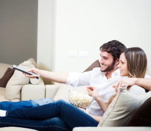 Young couple preparing to watch a movie