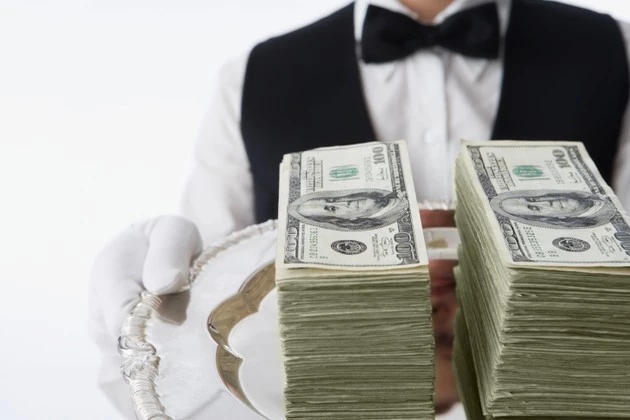 Close up of stacks of money on silver platter