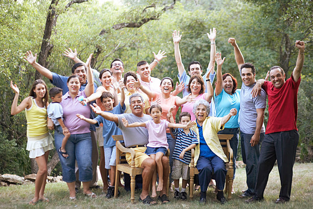 Portrait of a three generation family waving