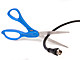 Scissors cutting through a coaxial cable on white