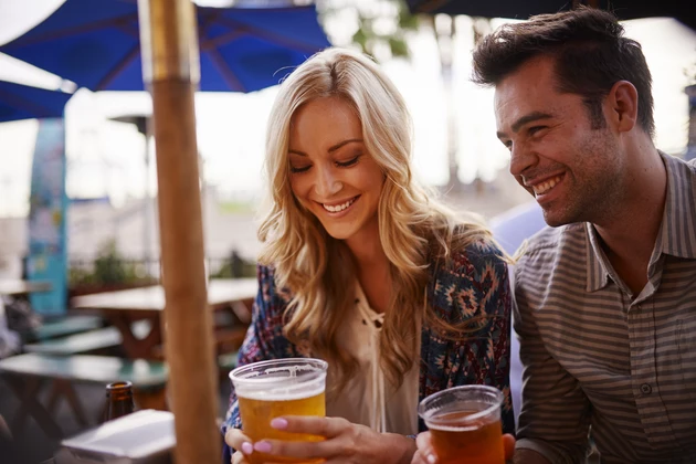couple drinking beer at outdoor bar