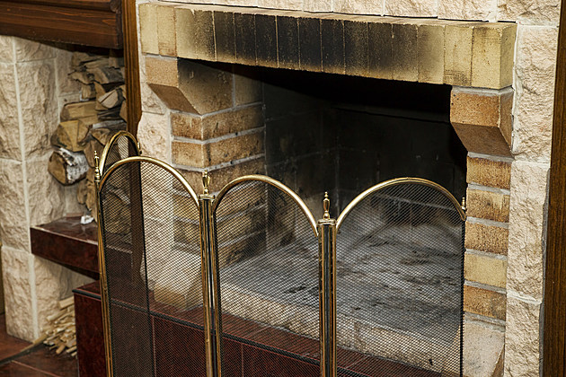 Dirty empty fireplace with firewood. Interior decor.